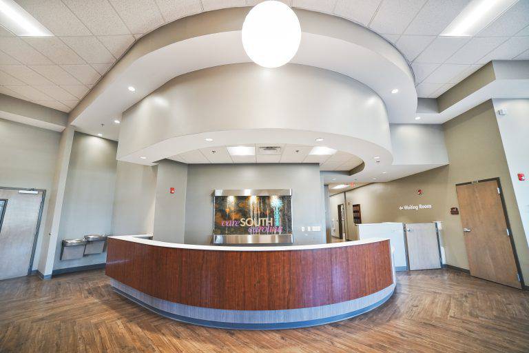 a reception area with a circular counter and wooden flooring